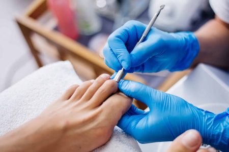pedicure-process-home-salon-pedicure-foot-care-treatment-nail-process-professional-pedicures-master-blue-gloves-make-pedicure