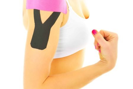 A picture of a special physio tape put on an injured arm muscles over white background